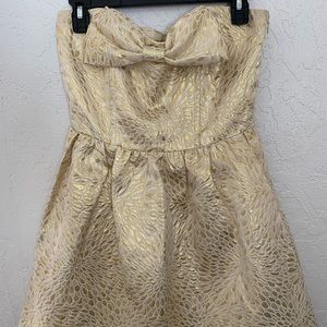 Gold and white strapless dress.